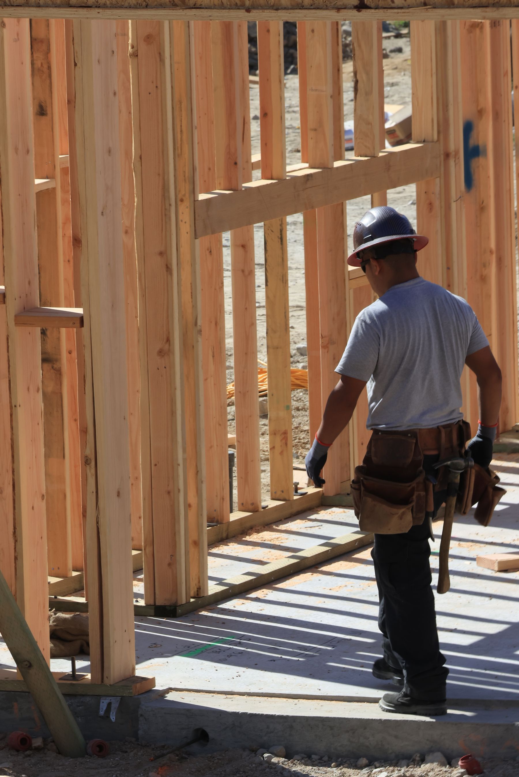 Worker framing a new house